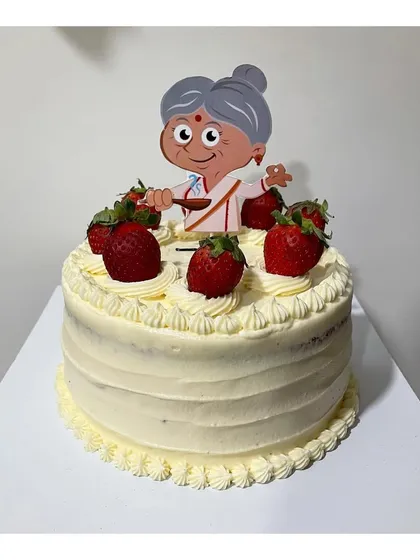 A vanilla strawberry cake with Italian buttercream for a granny's 75th birthday. The cake is topped with fresh strawberries and a cute grandma topper.
