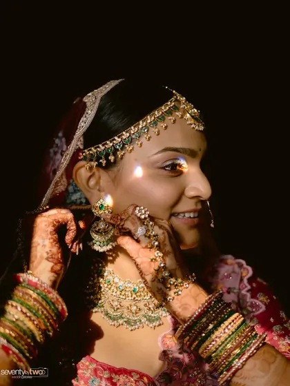 A close-up of a bride getting ready, the light catching the sparkle in her jewelry and the emotion in her eyes.