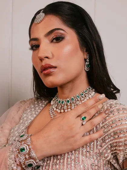 This angle showcases the beautiful hand jewelry and nail details, reminding students that every part of the look matters.
