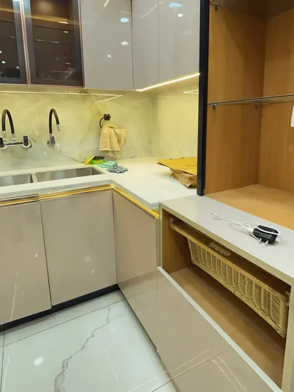 This kitchen includes smart storage solutions like this wicker basket drawer, perfect for storing vegetables like onions and potatoes that need ventilation.