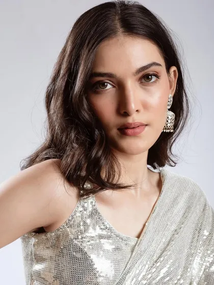 A direct, close-up portrait showing the subtle shimmer on the eyelids and the overall fresh, dewy finish of the skin.