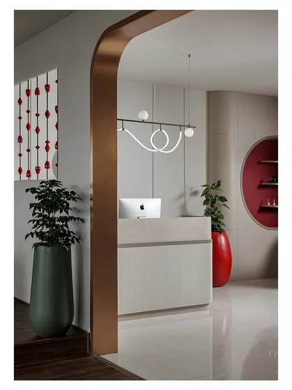 A view of the reception area through a bronze-finished archway. This shot highlights the layering of shapes, materials, and colors that I use to create depth and visual interest in my commercial interior designs.