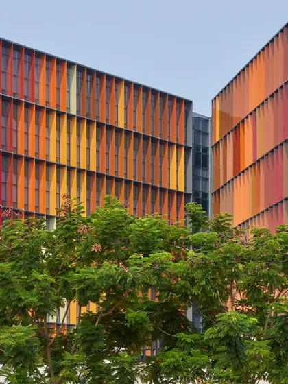 For the Infosys Campus in Nagpur, we designed a dynamic facade with colourful fins that are not merely aesthetic. Each fin is precisely angled to provide solar shading, reducing heat gain and glare, which significantly lowers the building's reliance on air conditioning and creates comfortable, naturally lit workspaces.