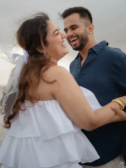 Barefoot on the beach with the wind in your hair. This candid shot from an Alibaug pre-wedding session is all about capturing genuine laughter and carefree movement. We want you to feel free, have fun, and let your connection shine.