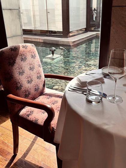 A table with a view of our tranquil water feature. The gentle sunlight and serene surroundings make for a perfect, relaxing lunch setting.