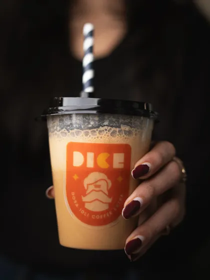A moody, dark shot of a coffee shake. This style creates a cozy and indulgent feeling, perfect for promoting rich, decadent beverages.