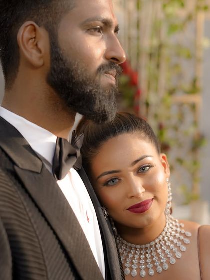 A tender and intimate moment between the couple, with the bride resting her head on the groom's shoulder, capturing the love and connection on their engagement day.