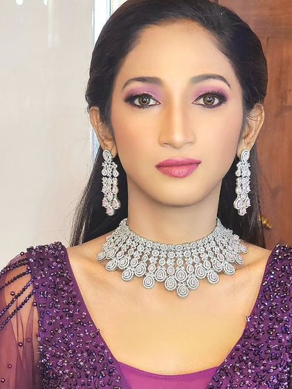 A close-up of a model wearing a beautiful American diamond choker and long earrings. This is a very glamorous look.