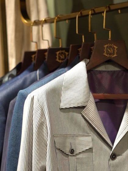 A rack of our shackets in various stripes and solid colors. This image shows the versatility of the shacket style, suitable for both daytime meetings and evening events.