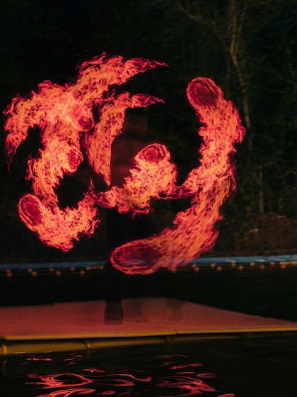 A duplicate image showing the abstract, fiery pattern created by an LED poi artist, highlighting the visual spectacle of our evening entertainment.