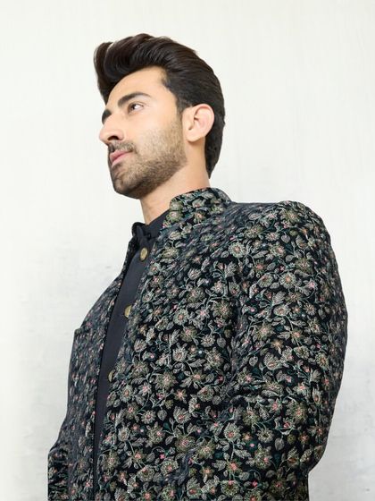 A side profile showcasing the floral embroidered jacket over a black kurta. This two-piece set is a perfect choice when you want to make a sophisticated statement.
