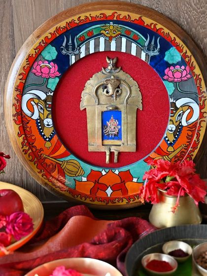 The Mangal frame styled with offerings of red flowers and fruits. The entire composition, from the hand-painted motifs to the central deity, is designed to evoke the fierce and determined spirit of Mars.