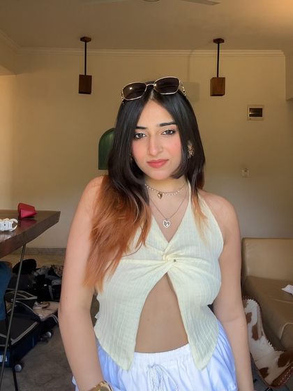 A sunny, indoor shot in a light yellow halter top. This is a great example of a simple, breezy, summer look.