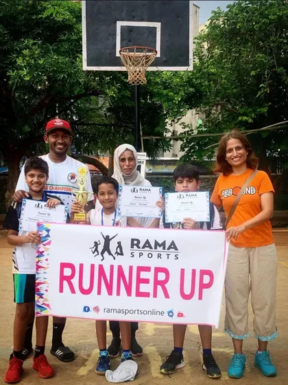 A junior team proudly displaying their runner-up banner and trophy. Every competition is a valuable learning experience.