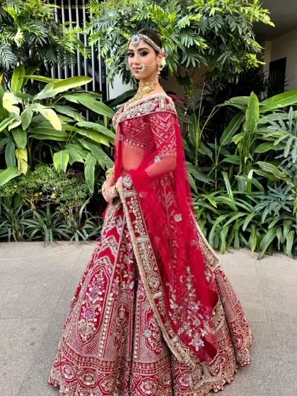A model in a classic bridal pose, her hair styled in a secure and elegant floral bun. This updo is a reliable choice for any bride on her wedding day.