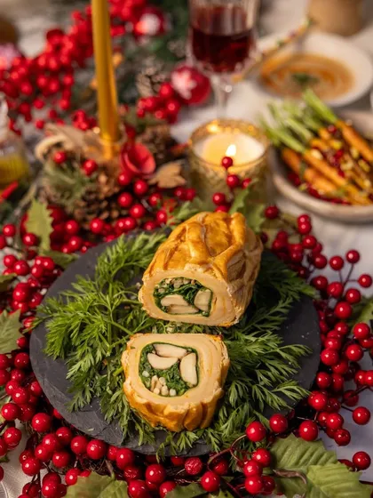 Our Chicken Wellington, presented on a bed of fresh greens and surrounded by festive red berries, makes for a stunning holiday centerpiece.