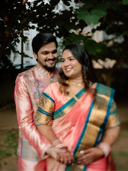 A warm, classic portrait of the newly engaged couple. The soft lighting and natural background create a timeless and romantic feel.