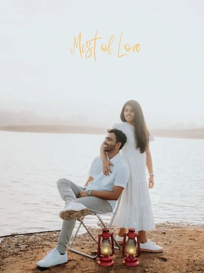 A romantic lakeside scene, with the couple using vintage lanterns as props. The warm glow of the lantern adds a magical, old-world touch to the evening light.