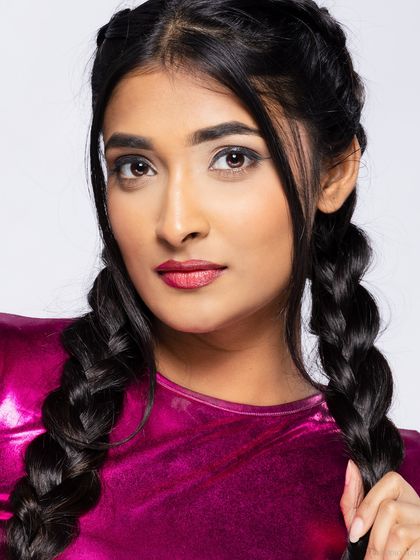 A beauty close-up from the same shoot, focusing on the hair and makeup.