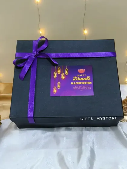 A clean shot of the closed black hamper box with the custom tag and purple ribbon, ready for delivery.