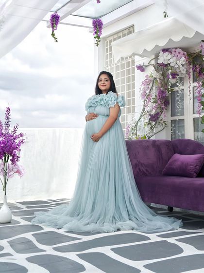 Our Elsa gown looks stunning against the vibrant purple couch in our studio. We have multiple setups to match the vibe of your chosen dress.