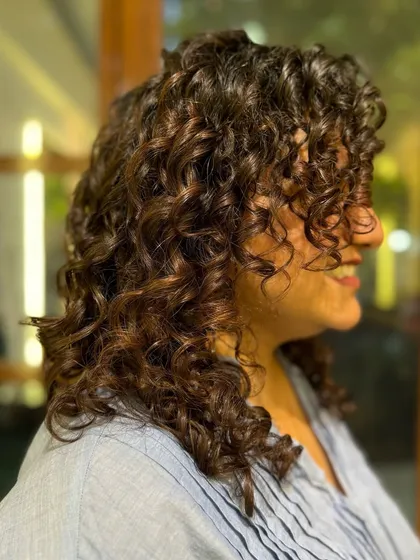 Nothing like a warm Mocha to enrich dark curls. This subtle no-bleach balayage adds a soft, coffee-toned dimension that catches the light beautifully.