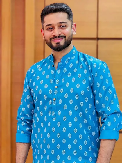 A clean, bright, and friendly look in a classic blue kurta. This image is perfect for ethnic wear brands looking for a model who can represent everyday traditional fashion with a warm and approachable smile.