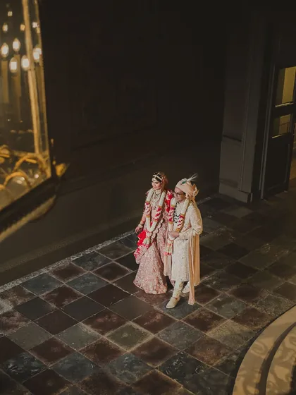 An artistic shot of the couple walking through the historic corridors of the palace. We help scout the best photo locations within your chosen venue.