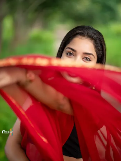 A playful shot where the model peeks over her saree. This adds a touch of mystery and fun to the portfolio.