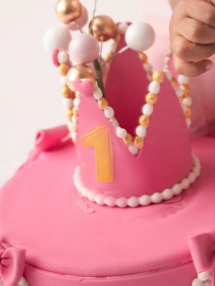 It's all in the details. A close-up of the beautiful crown-topped cake from a princess-themed first birthday session, just before the smashing fun begins.
