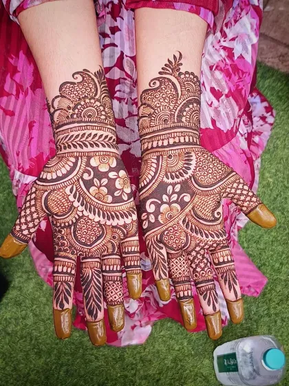 A rich and detailed traditional mehandi design, with full coverage on the palms and fingers.