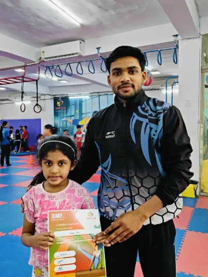 Another proud student with her "JUMP" program certificate and her coach.