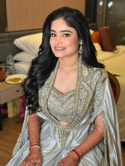 A full view of the romantic reception look. The soft waves and glowing makeup create an aura of effortless elegance.