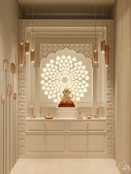 This all-white mandir design achieves a divine glow with a large, backlit floral mandala behind the Ganesha idol. The intricate jali arch and modern pendant lights add layers of sophistication and brightness.