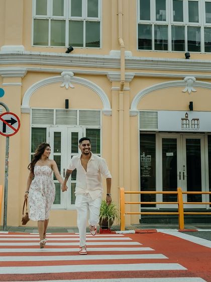 A fun, Beatles-inspired crosswalk moment in Old Town Phuket. This shot shows that even a post-wedding shoot can be filled with the same energy and playfulness as a pre-wedding session.