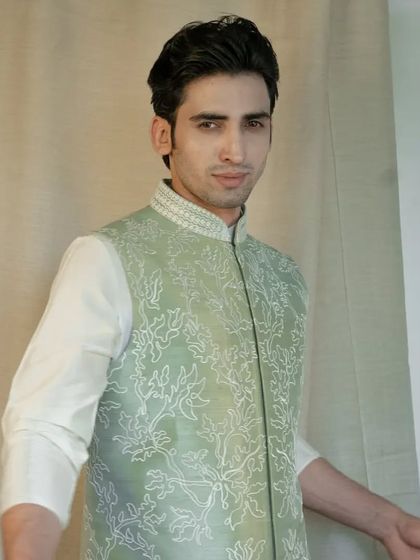 This jacket, paired with a silk kurta pajama, harmonizes perfectly for a look that is both elegant and fresh, ideal for daytime celebrations.