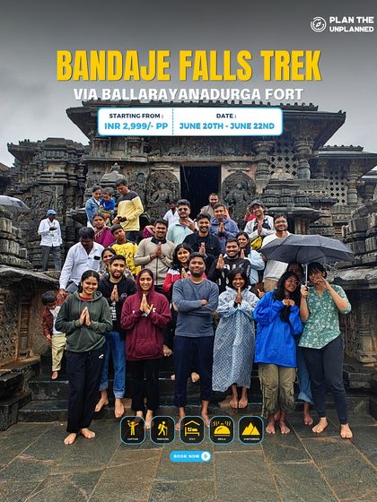 A large group poses in front of a temple during the Bandaje Falls trek.