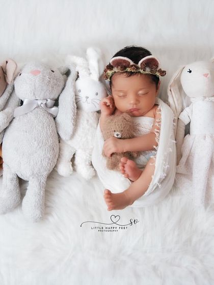This little one is surrounded by all their best friends. This sweet lineup of stuffed animals creates a feeling of comfort, friendship, and love.