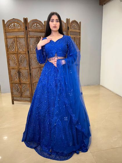 A full-length shot of the stunning blue lehenga. The full sleeves and matching dupatta complete this glamorous pre-loved look.