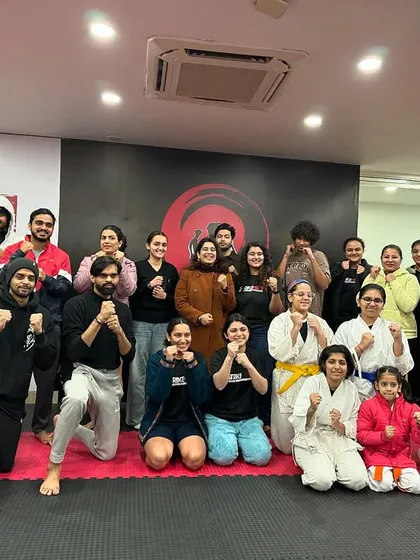The full group of participants from our "Stronger Minds, Stronger Moves" workshop. These events bring people together to learn about both physical defense and mental resilience in a supportive community setting.