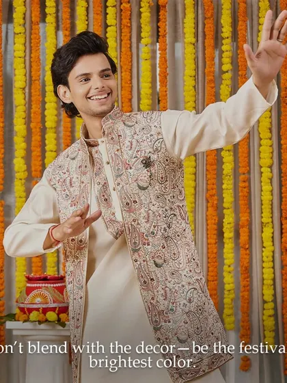 This Diwali, don't blend with the decor, be the festival's brightest color. This off-white kurta with a stunning embroidered jacket is perfect for adding sophistication to your celebrations.