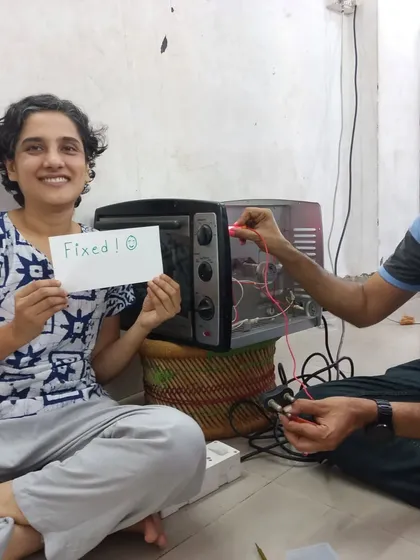 The best feeling in the world: Fixed! A happy participant proudly shows off her repaired oven. Our goal is to empower you with the skills and confidence to fix your own belongings, saving money and reducing waste.