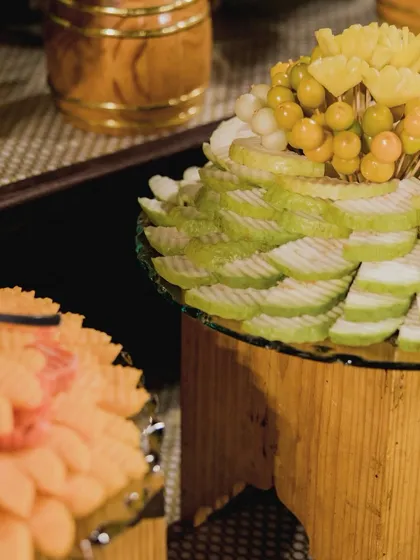 A display of sliced guava and other exotic fruits, beautifully arranged on tiered stands. This adds height and visual interest to the fruit counter.