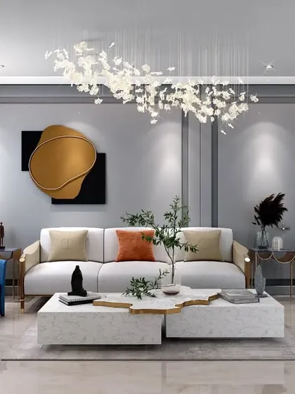 An elegant living room featuring a mix of modern and classic elements. The space is defined by sophisticated furniture, a statement chandelier, and curated art pieces, creating an upscale yet trendy feel.