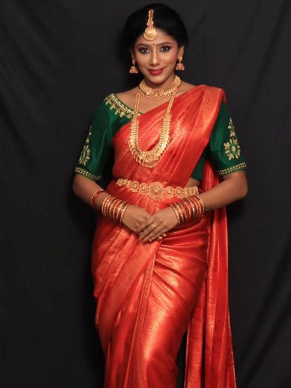 A full view of the photoshoot look. The classic Nivi drape is elevated by the crisp pleats and the rich color of the Kanchipuram silk saree.