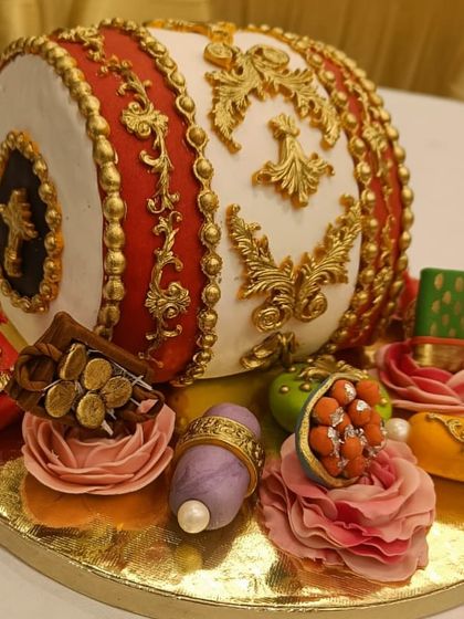 Another angle of the dhol cake, showcasing the incredible detail of the golden ropes and decorative elements that make it look so realistic.