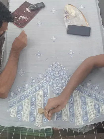 True luxury lies in the details. This is a glimpse into my workshop, where skilled artisans bring my designs to life with meticulous hand-embroidery, ensuring every garment is a unique piece of art.