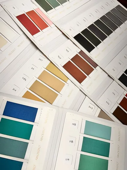 Color cards from our 'Absoluto' fabric line, showcasing a rainbow of options for suits, blazers, and trousers.