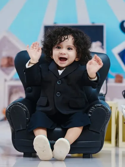 A big, happy wave from our little boss, showing his playful side during the corporate-themed photoshoot.