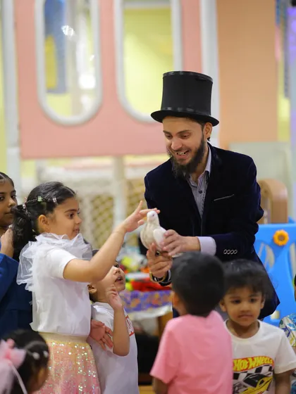 A magician performs for the children at the construction party, showing that a touch of magic fits in perfectly with any theme.